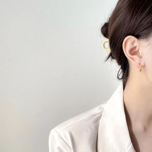 Elegant gold twisted hoop earrings for women featuring a minimalist braided texture design