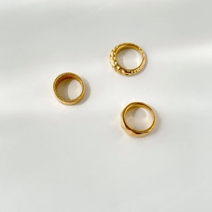 Detailed view of three gold vintage rings with textured patterns and hammered finish