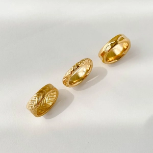 Three-piece gold plated ring set with wheat texture and hammered irregular patterns