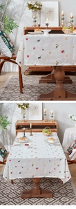 Detailed view of white thickened tablecloth with colorful small flower embroidery patterns