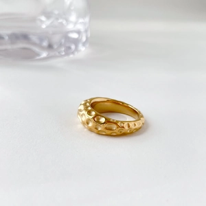 Detail of French vintage gold ring featuring a unique hammered meteorite crater texture
