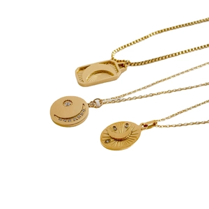 Elegant gold celestial necklace set featuring moon and star pendants with rhinestones