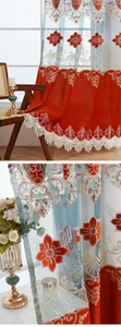 Close-up of European baroque gold embroidery on red and light blue luxury curtains