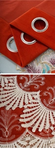 Close-up of red velvet curtains with white floral embroidery and silver metal grommets
