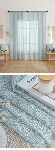 Detail of light blue floral lace sheer curtain showing delicate scallop texture and light