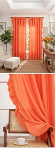 Detail of bright orange ruffled curtain fabric with rod pocket design and airy texture
