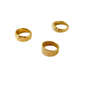 Three-piece gold textured ring set with hammered, wavy, and woven braided wheat patterns