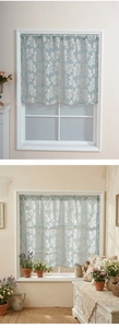 Detail of light blue floral sheer curtain with white blossoms for country style windows