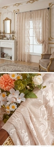 Detail of vintage French lace curtain with floral patterns and ruffled edges in cream