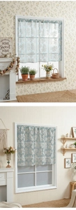 Detail of light blue lace cafe curtain with white floral embroidery for kitchen windows