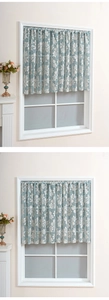 Close-up of light blue floral lace cafe curtain with rod pocket on a white window