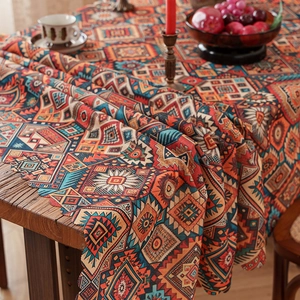 Bohemian geometric pattern tablecloth with wavy edges on a wooden dining table