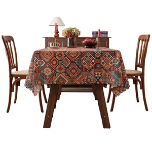 Bohemian style tablecloth with geometric ethnic patterns on a wooden dining table
