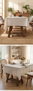 Detailed close-up of cream lace tablecloth with scalloped edges on a wooden table
