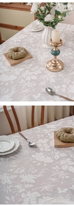 Detailed view of vintage embossed floral pattern and lace edge on polyester tablecloth