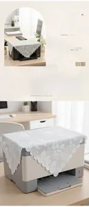 Close-up of white lace dust cover with floral patterns and wavy lace edges on furniture