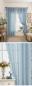 Close-up of light blue sheer curtain with ruffled edge details on a black metal rod