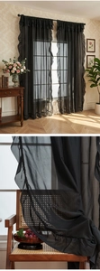 Close-up of black sheer curtain with elegant ruffle edge detail and rod pocket design