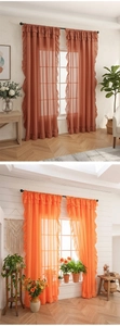 Detailed view of terracota and orange ruffled sheer curtains with rod pocket design