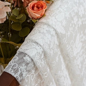 White floral lace curtain with intricate mesh embroidery and light-filtering sheer fabric