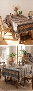 Detail of bohemian tablecloth with geometric patterns and white fringe tassels