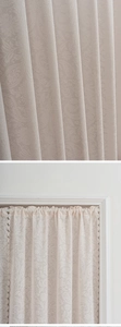 Detail der cremefarbenen Spitzenvorhang mit Paisley-Muster und gewellten Kanten