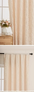 Detail of beige floral lace curtains with intricate embroidery and rod pocket header