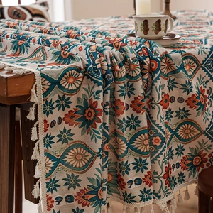 Bohemian floral printed tablecloth with tassel fringe on a rustic wooden dining table