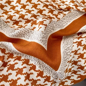 Classic caramel and beige houndstooth silk scarf with soft fabric drapes and elegant patterns