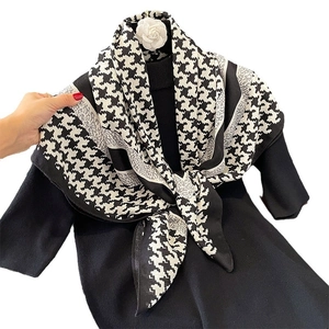 Classic houndstooth silk scarf with white camellia flower on black sweater base
