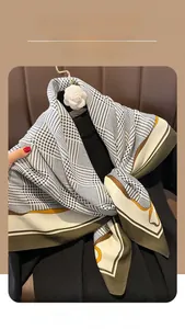 Detail of vintage plaid scarf with houndstooth pattern and elegant camellia brooch