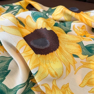 Macro detail of sunflower print on premium herringbone twill fabric showing fiber texture