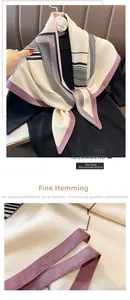 Detail showing fine hemming craftsmanship and geometric stripes on the silk texture scarf