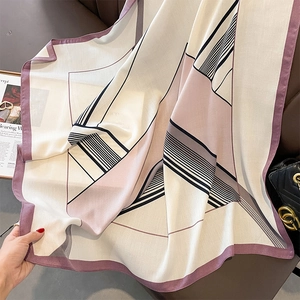 Detail showing the geometric striped pattern and soft texture of this square silk scarf
