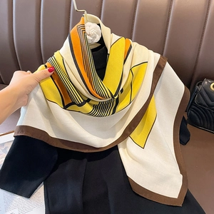 Striped square scarf with vibrant yellow and orange geometric patterns on cream background