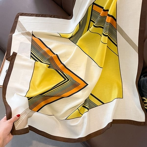 Macro shot of geometric striped silk scarf with orange and black contrast pattern