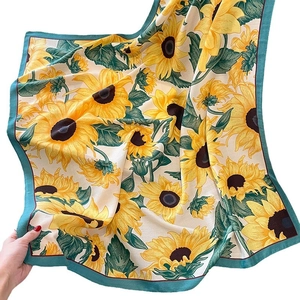 Elegant silk scarf with yellow sunflower print and dark green border on white background