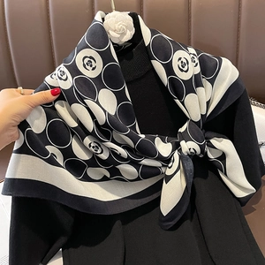 French camellia scarf with black and white polka dots and a white flower brooch pin