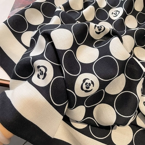 Close-up of black and white camellia pattern scarf showing soft herringbone texture