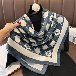 Blue and white camellia print silk scarf featuring classic polka dots and elegant drape
