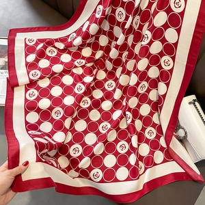 Detail of red and cream camellia flower floral silk scarf with polka dot patterns