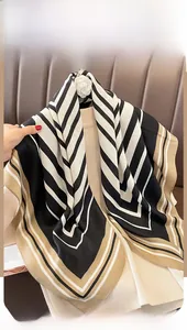 Detail view of striped square scarf featuring high-quality silk-like texture and draping
