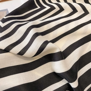 Close-up of the black and white striped scarf showing soft woven texture and drape