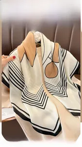 Macro detail of striped silk scarf with orange accents hanging on a leather chair