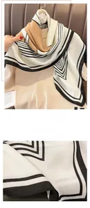 Detailed close-up of fine overlock stitching on a striped knit scarf with twill texture