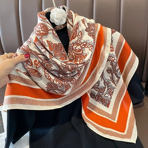 Retro paisley pattern shawl with vibrant orange and ivory tones and silky texture