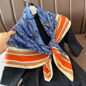 Vintage paisley pattern scarf with orange stripes and decorative flower brooch