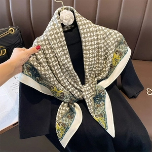 Classic paisley silk scarf featuring vintage chain patterns over a black knit top