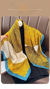 Detail of color-block scarf with wavy patterns on a camellia hanger with soft lighting