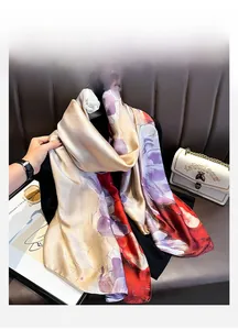 Detail of floral printed silk scarf with elegant pattern and glossy satin finish